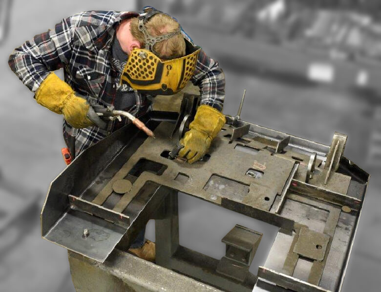 Welder using a fixture to locate a component on a weldment